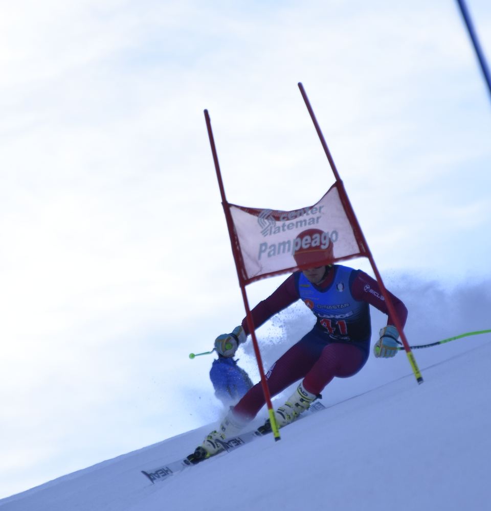 Racer passing a red giant slalom gate
